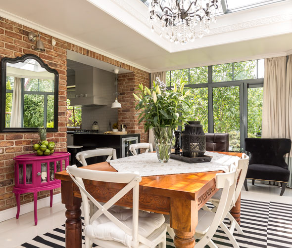 bright dining area with a wooden table chairs and floral centerpiece showcasing modern design elements and natural light perfect for dinner gatherings and family meals