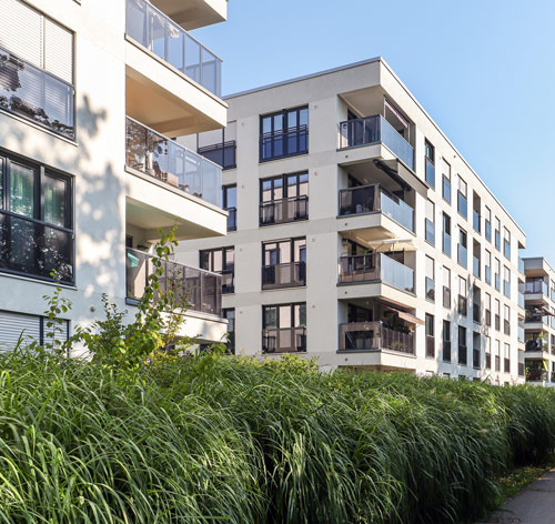 Modern apartment building with balconies and surrounding greenery in West London.
